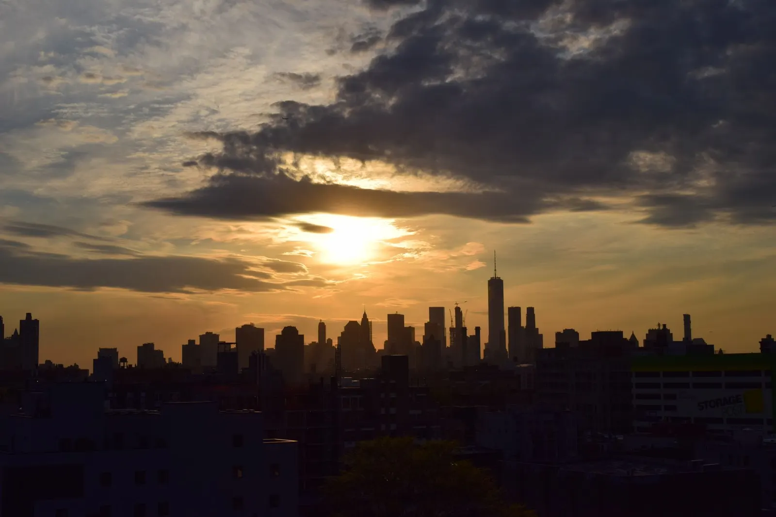 The New York City skyline silhouetted against a golden-hour sunset